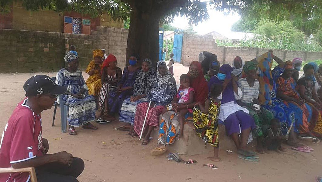 August 6, 2020. The alkali (the village head) in front of the women farmers at the Bantaba in Samba Tacko Village Upper River Region, The Gambia. 